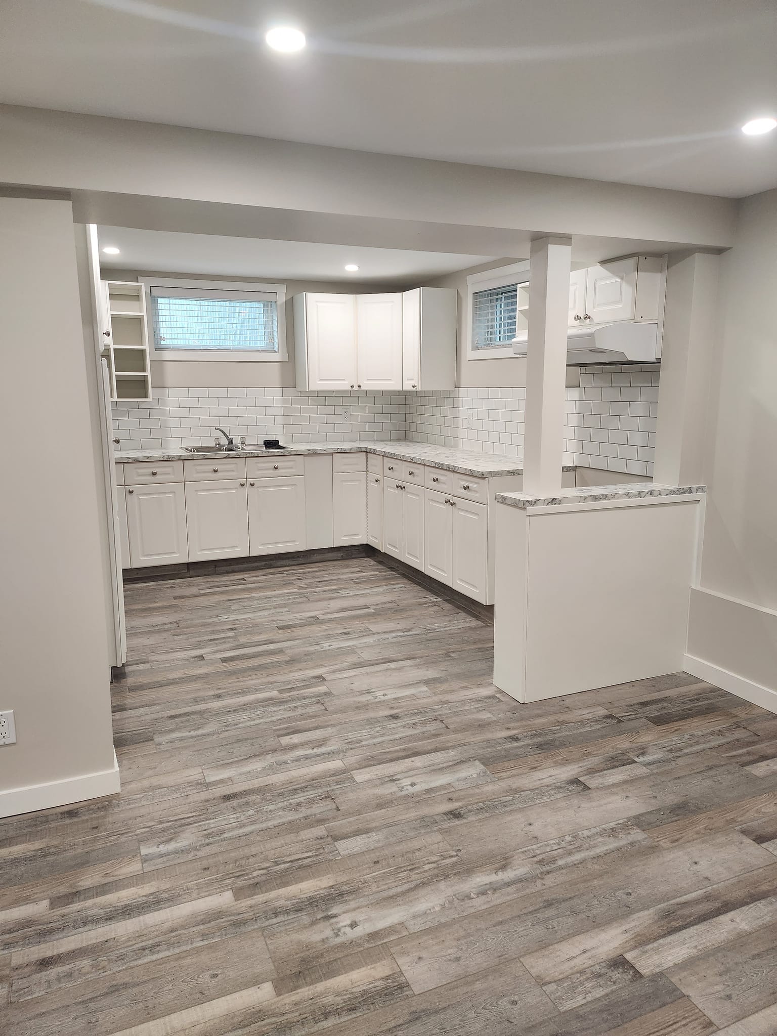 Flooded basement suite kitchen renovation completed by Rempel's Painting and Drywall